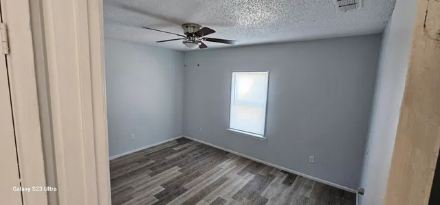 a view of an empty room and a window