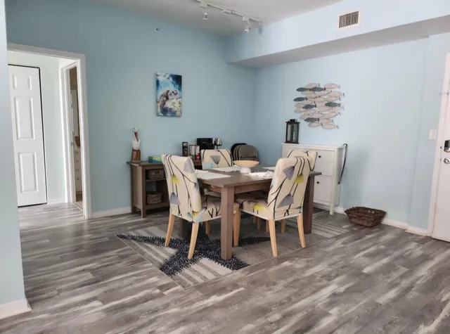 a view of a dining room with furniture and wooden floor