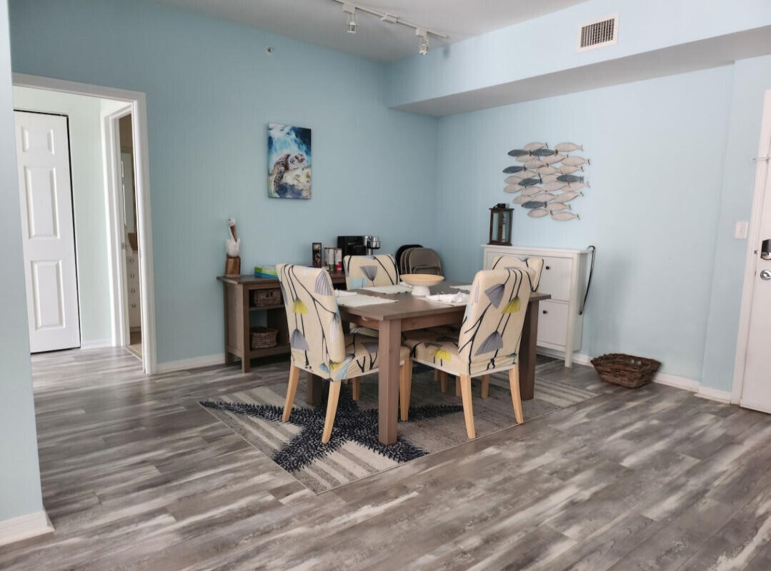 802 West Windward Way, Unit 309 Lantana, FL 33462 - Photo 3 of 10 a view of a dining room with furniture and wooden floor