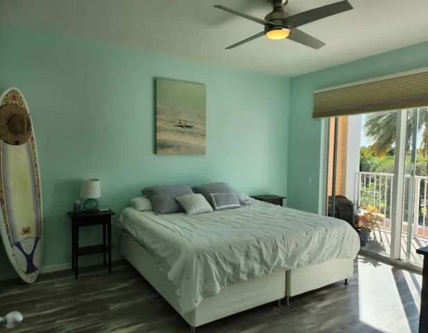 a bedroom with a bed a window and a chandelier