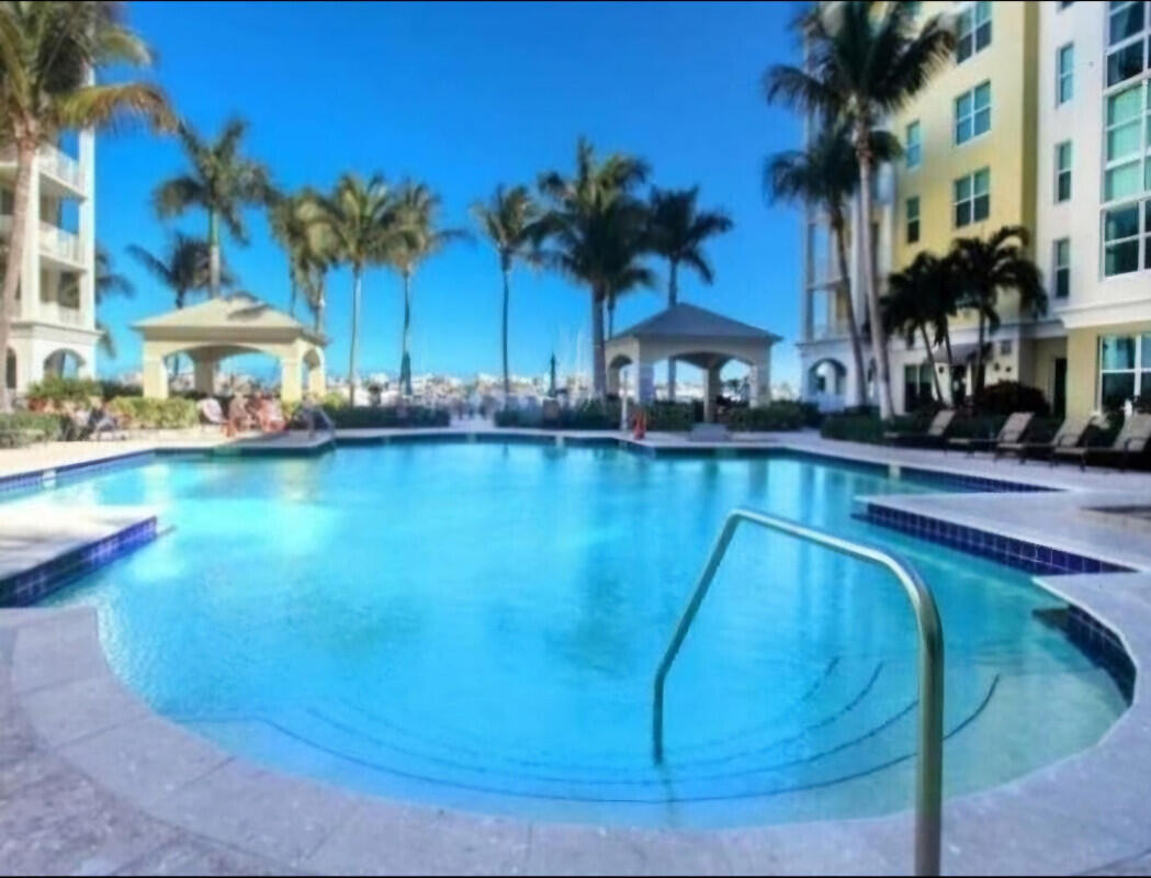 802 West Windward Way, Unit 309 Lantana, FL 33462 - Photo 8 of 10 a view of a swimming pool and a yard