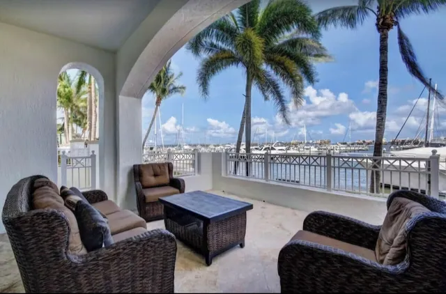 a living room with furniture fireplace and a large window