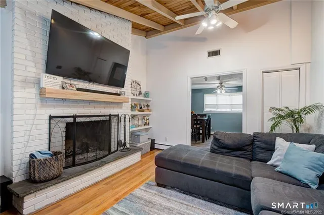 a living room with furniture and a fireplace