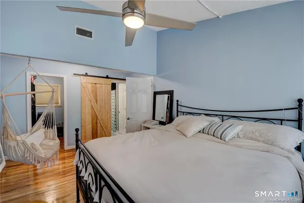 a bedroom with a bed and a mirror