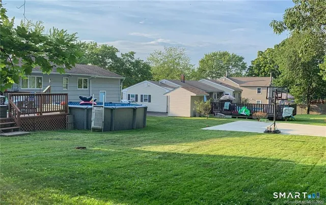 a front view of a house with a yard and trees