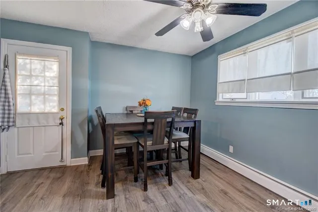 a view of a dining room with furniture window and wooden floor