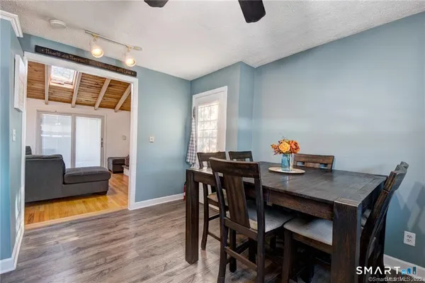a view of a dining room with furniture and wooden floor