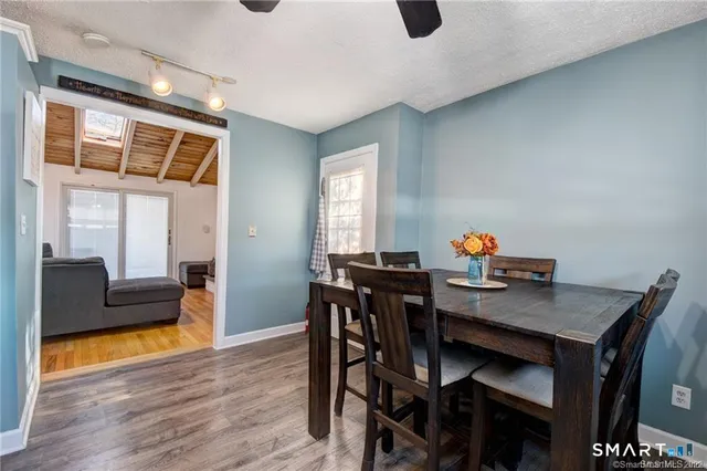 a view of a dining room with furniture and wooden floor