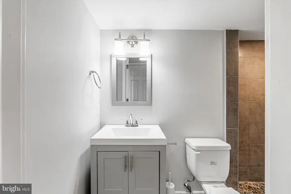 a bathroom with a toilet sink and mirror