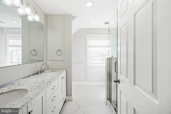 a bathroom with a granite countertop sink mirror and a