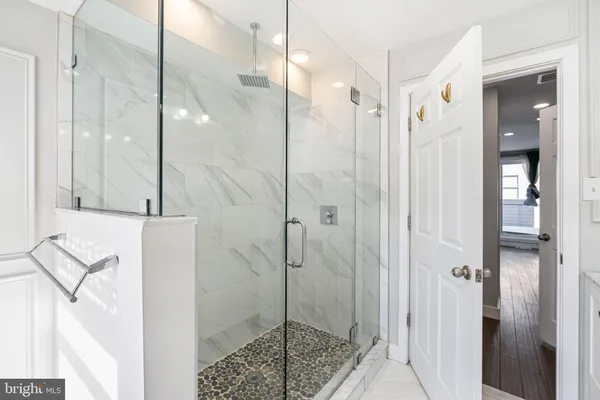 a bathroom with a shower and a sink