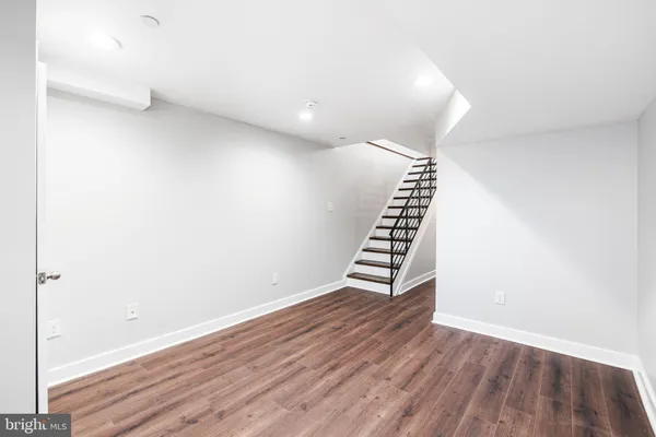a view of wooden floor and windows in a room