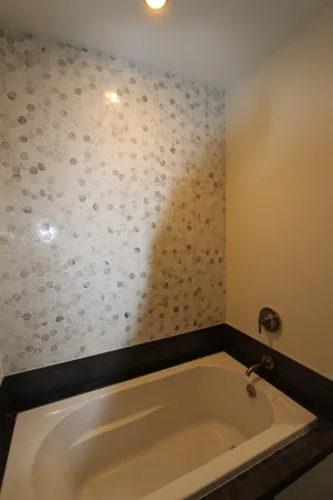 a bathroom with a sink a shower and a mirror