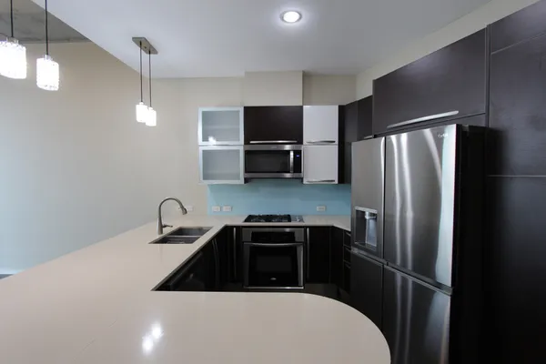 a kitchen with a refrigerator and a sink