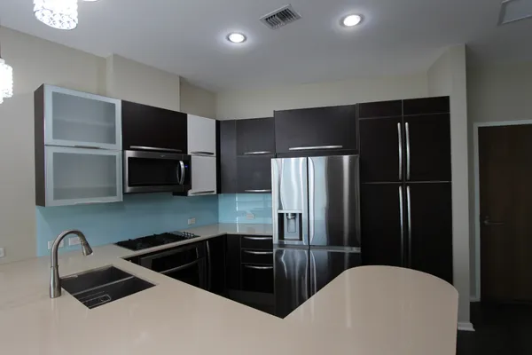 a kitchen with a refrigerator a sink a stove and cabinets