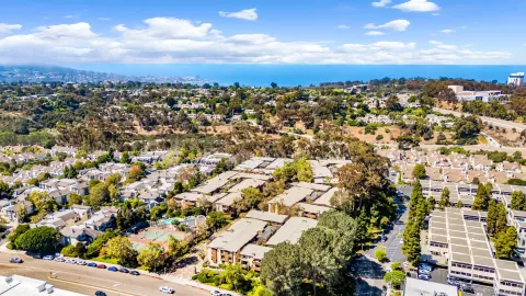 an aerial view of a multi story building with yard