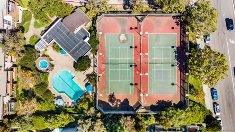 an aerial view of residential houses with outdoor space