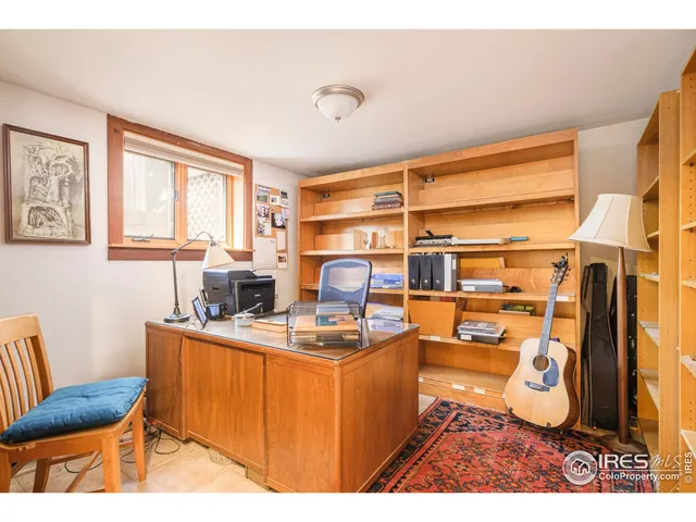 a room with furniture a flat screen tv and a window