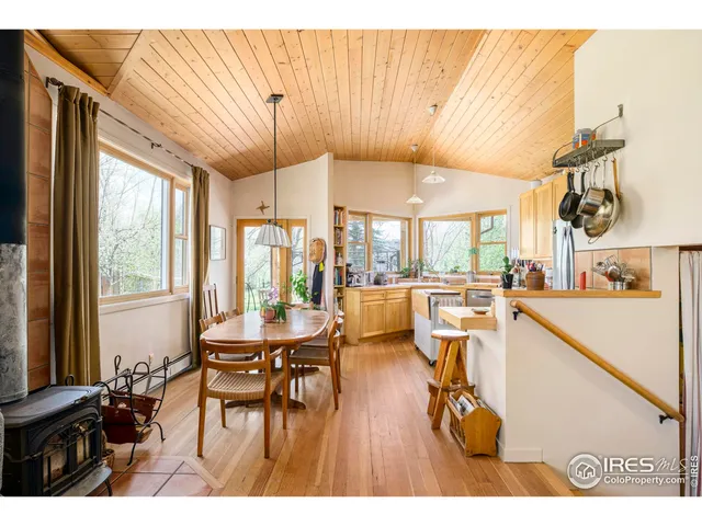 a dining room with furniture and a large window