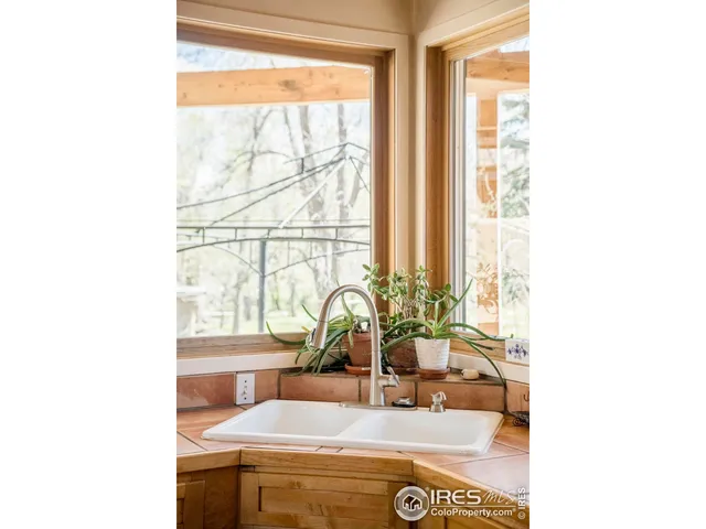 a room with a sink and a large mirror