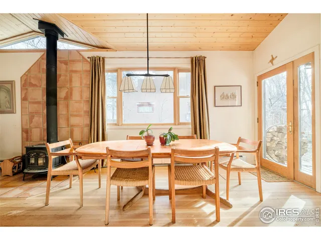 a view of a dining room with furniture large windows and wooden floor