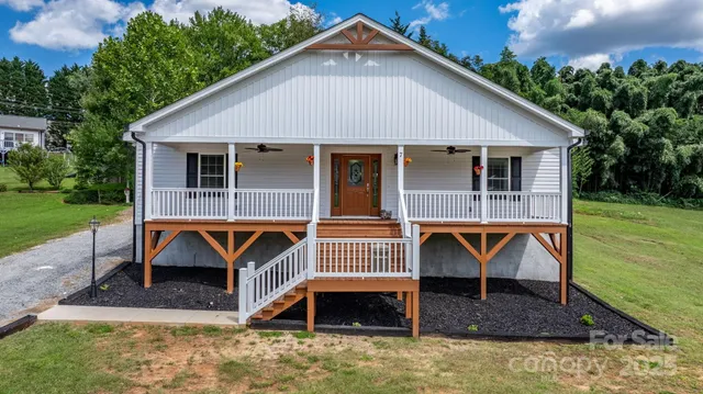 a front view of a house with yard porch and furniture