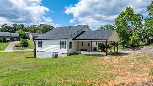 a view of a house with a yard porch and sitting area