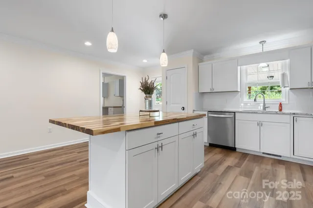 a kitchen with granite countertop white cabinets and white appliances