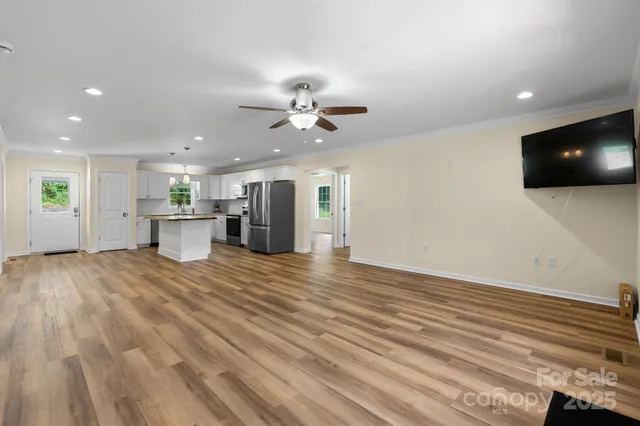 a view of an empty room with a kitchen