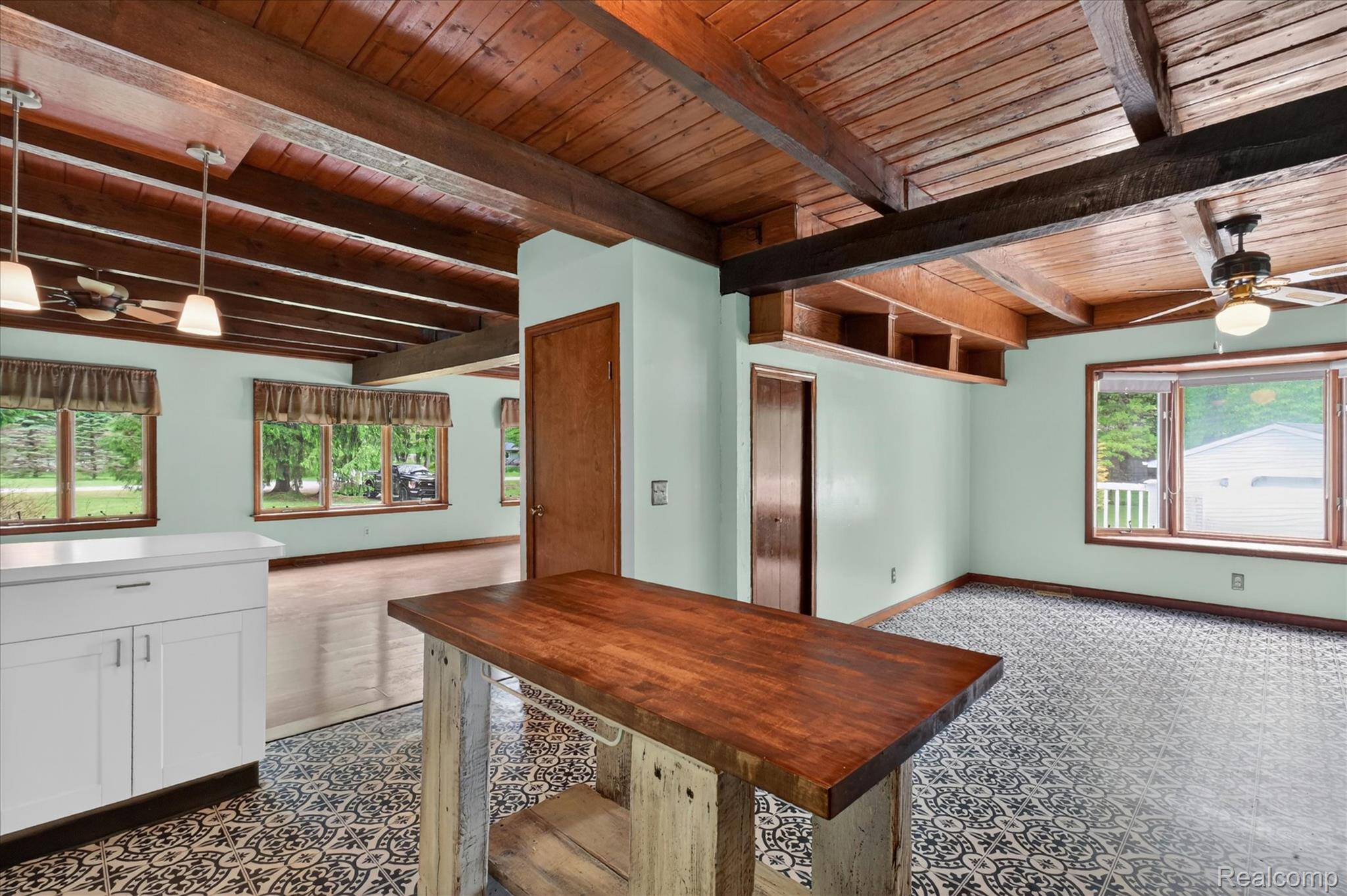 41303 Harris Road Belleville, MI 48111 - Photo 21 of 49 Unfurnished dining area featuring a ceiling fan, a wood ceiling with exposed beams, and dark flooring