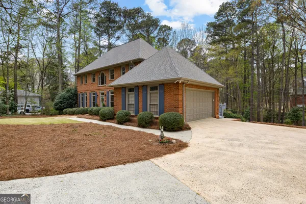 a view of a house with pool and tree s