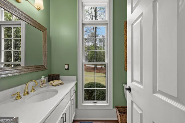 a spacious bathroom with a double vanity sink and mirror