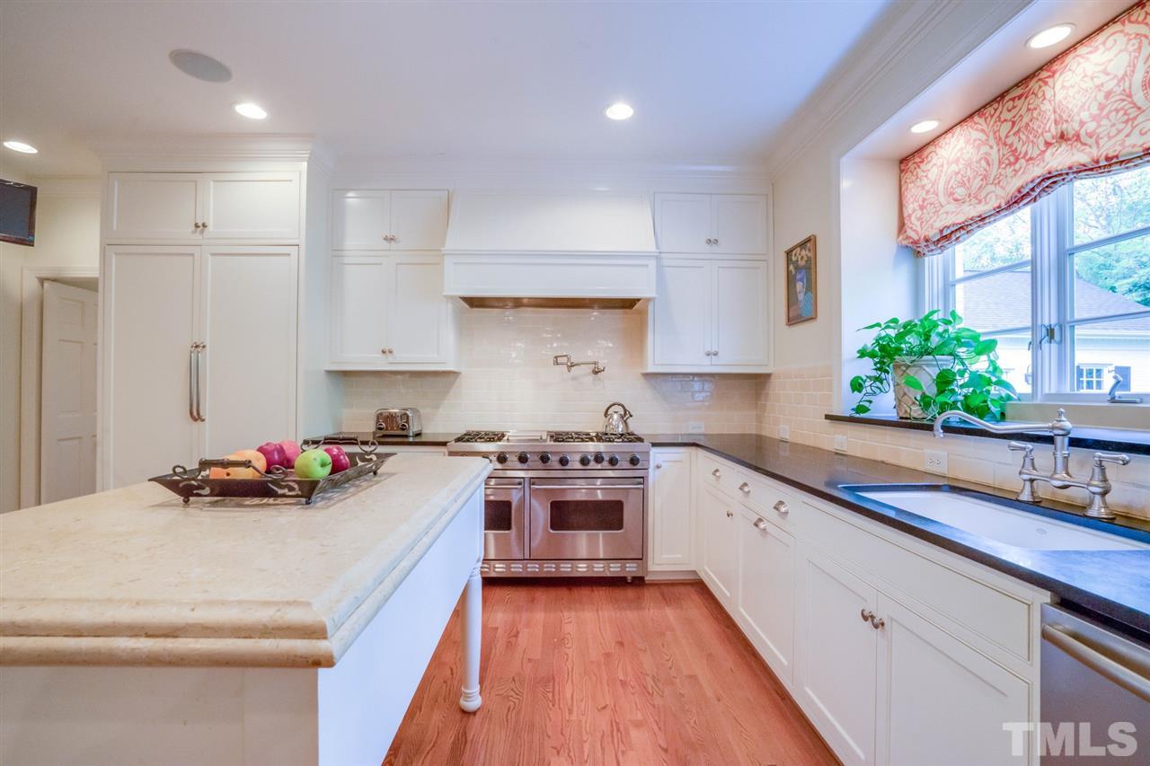 700 Yarmouth Road Raleigh, NC 27607 - Photo 11 of 25 a kitchen with a white stove top oven and white cabinets