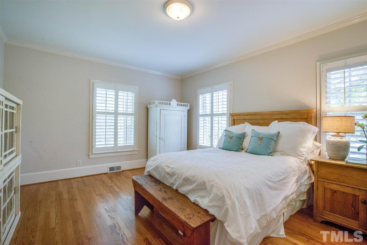 700 Yarmouth Road Raleigh, NC 27607 - Photo 15 of 25 a bedroom with a bed and wooden floor