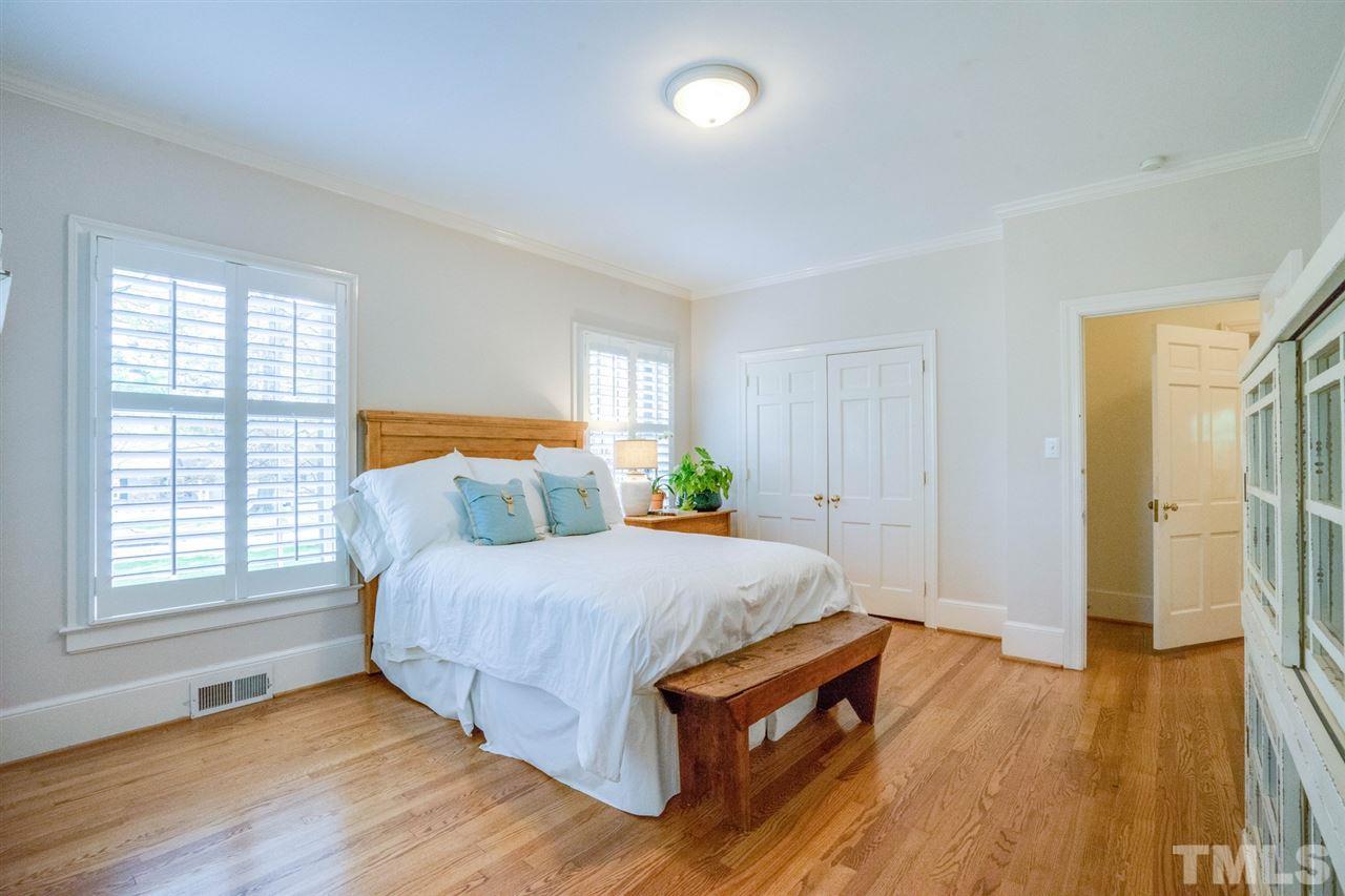 700 Yarmouth Road Raleigh, NC 27607 - Photo 16 of 25 a bedroom with a bed and wooden floor