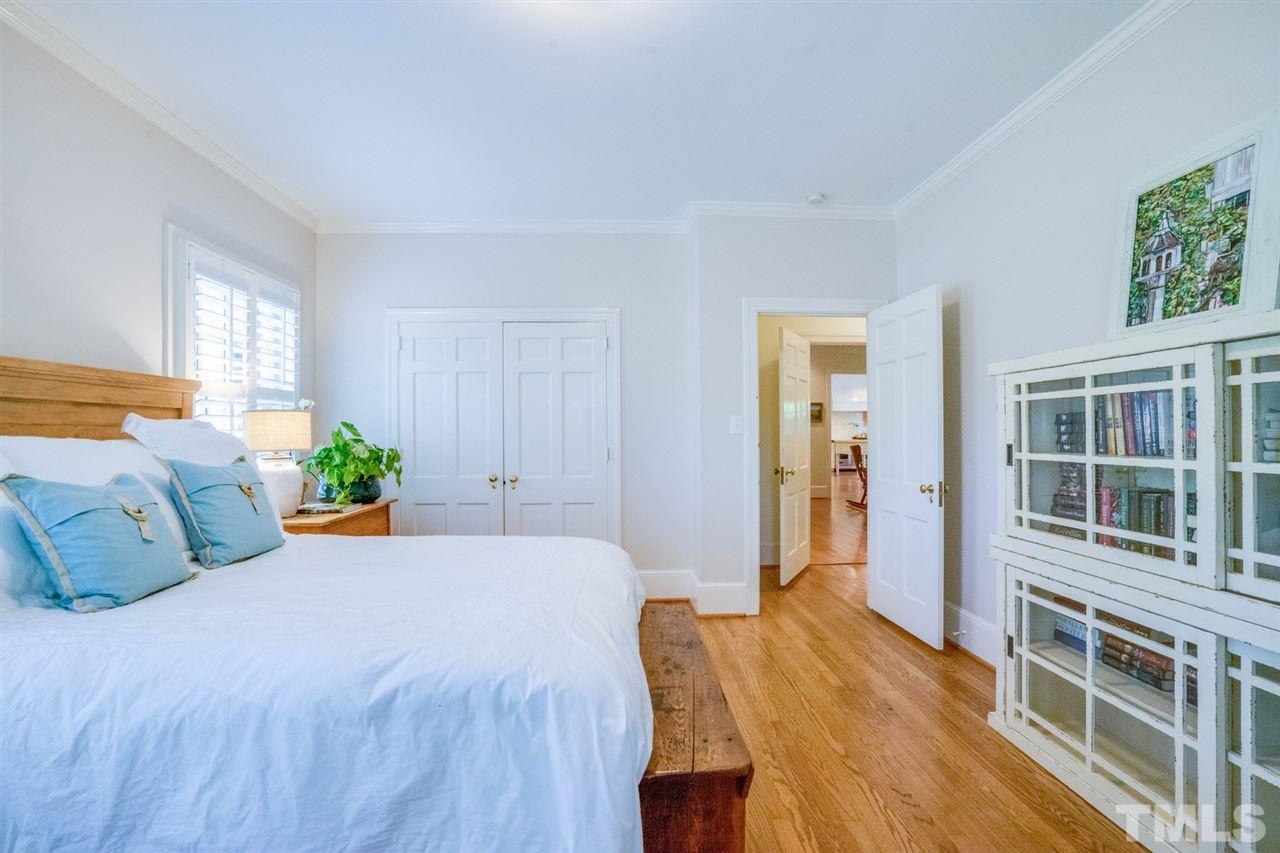 700 Yarmouth Road Raleigh, NC 27607 - Photo 17 of 25 a bedroom with a bed table and a window