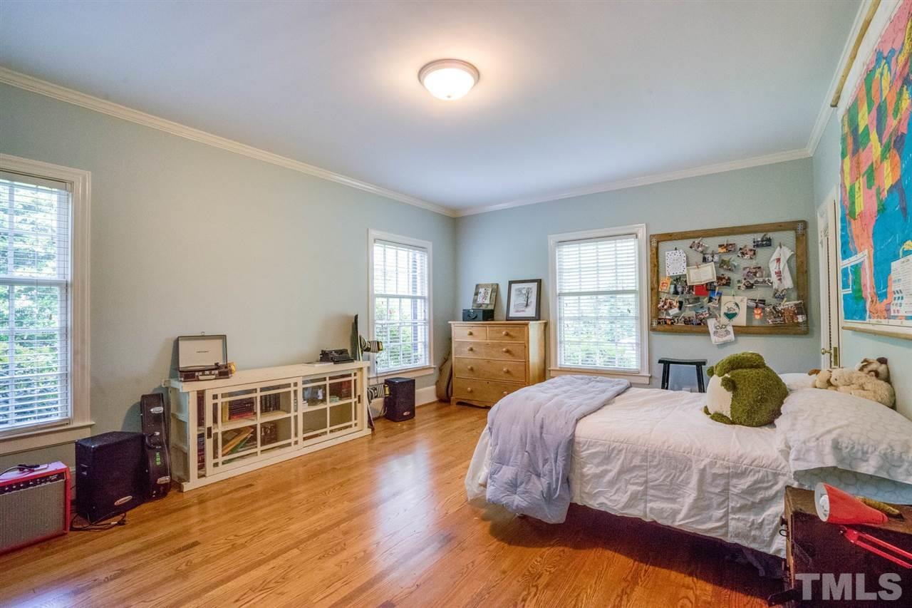 700 Yarmouth Road Raleigh, NC 27607 - Photo 19 of 25 a bedroom with a bed and wooden floor