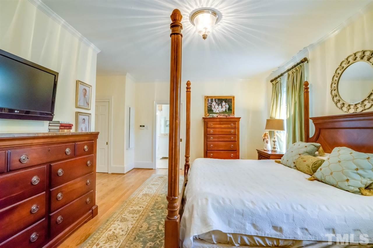 700 Yarmouth Road Raleigh, NC 27607 - Photo 20 of 25 a bedroom with a bed and wooden floor