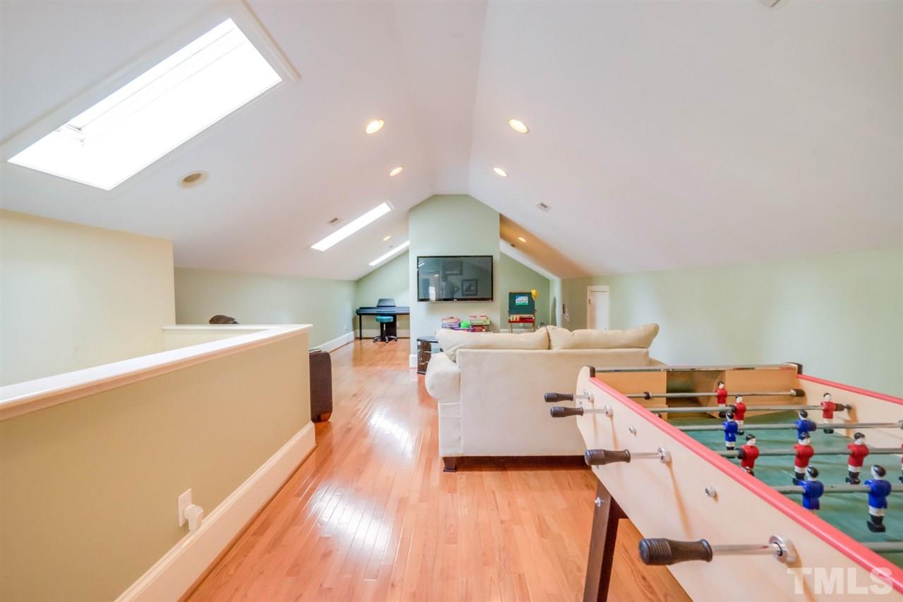 700 Yarmouth Road Raleigh, NC 27607 - Photo 22 of 25 a living room with furniture and a wooden floor