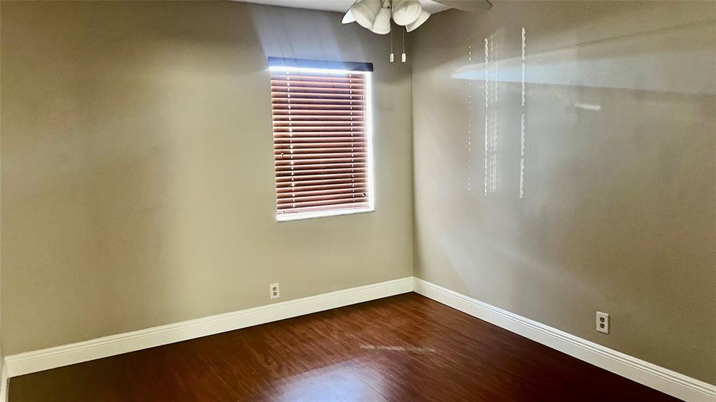 1874 Southwest 81st Lane, Unit 1874 Davie, FL 33324 - Photo 16 of 21 a view of an empty room with wooden floor and a window