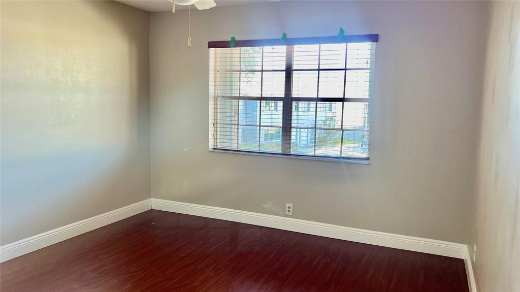 1874 Southwest 81st Lane, Unit 1874 Davie, FL 33324 - Photo 17 of 21 an empty room with wooden floor and windows