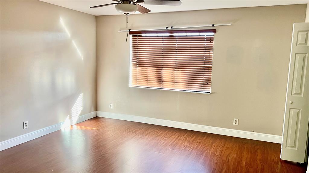 1874 Southwest 81st Lane, Unit 1874 Davie, FL 33324 - Photo 18 of 21 an empty room with wooden floor and a window