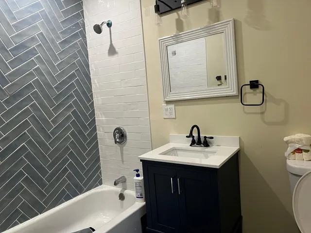 a bathroom with a sink a toilet and shower