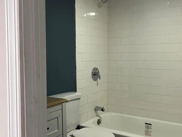 a bathroom with a bathtub and shower