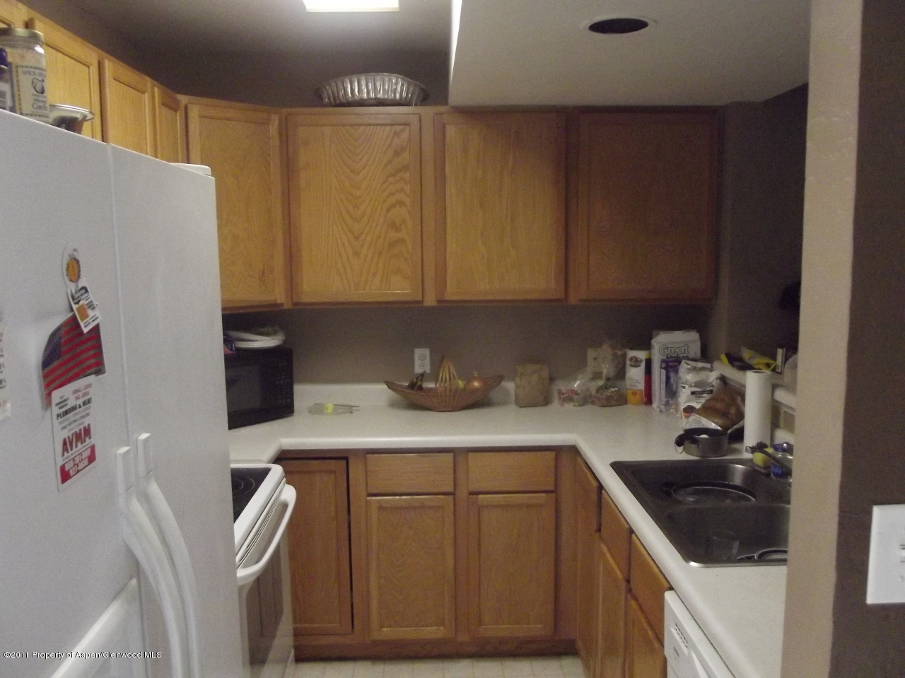 2502 Rail Avenue Rifle, CO 81650 - Photo 2 of 5 a kitchen with a sink a stove and a refrigerator