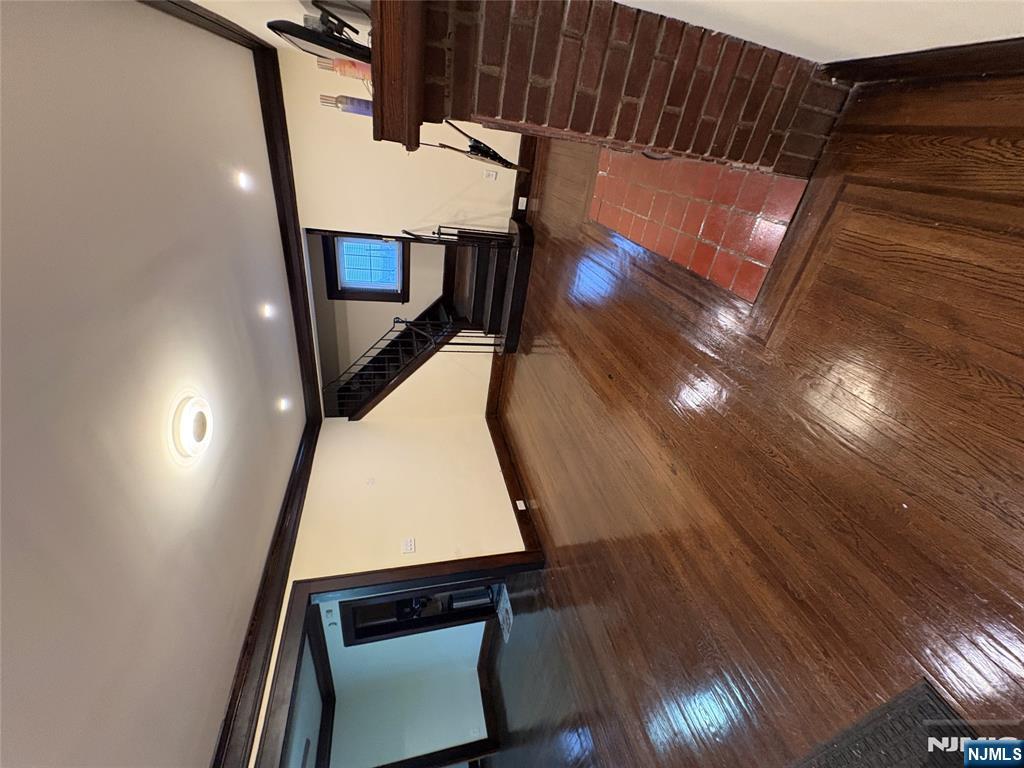 5 Hamilton Avenue Kearny, NJ 07032 - Photo 2 of 3 a view of an empty room with wooden floor and stairs