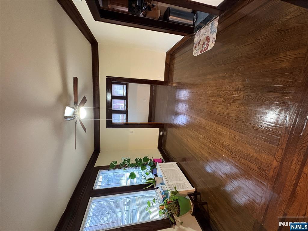 5 Hamilton Avenue Kearny, NJ 07032 - Photo 3 of 3 a view of an empty room with wooden floor and a window