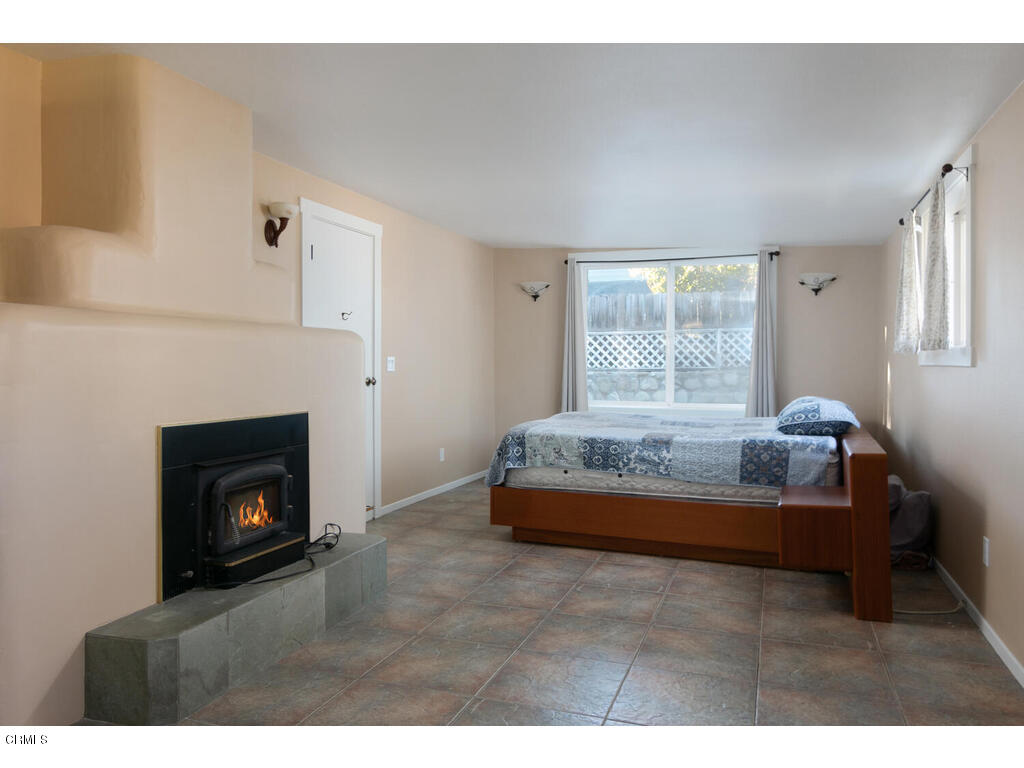 564 Burnham Road Oak View, CA 93022 - Photo 12 of 37 a bedroom with a bed and a fireplace