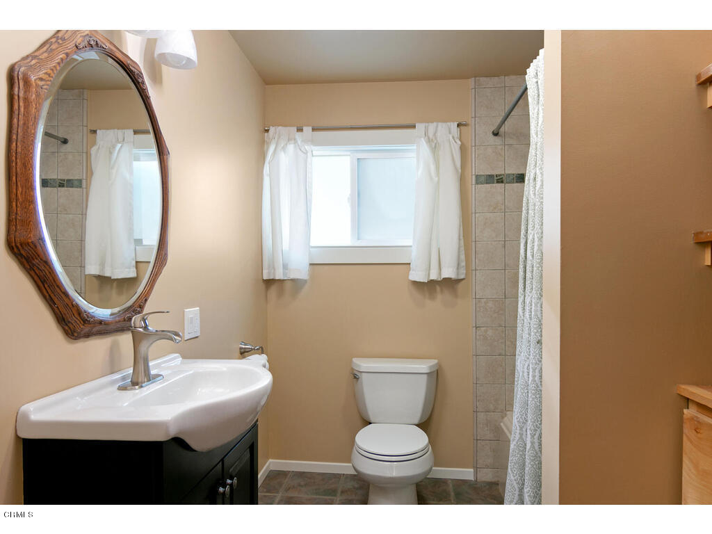 564 Burnham Road Oak View, CA 93022 - Photo 15 of 37 a bathroom with a toilet sink and mirror