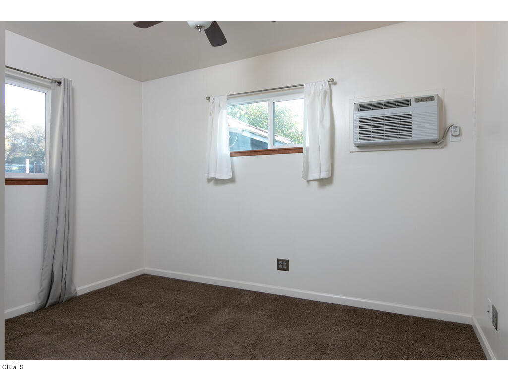 564 Burnham Road Oak View, CA 93022 - Photo 22 of 37 a view of an empty room with wooden floor and windows